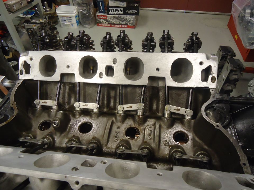 Engine block with cylinder head removed, showing valves and lifters