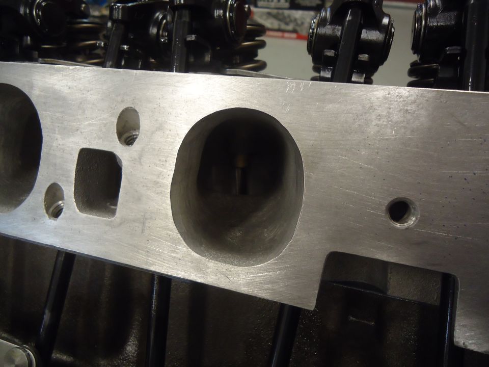 Aluminum engine cylinder head with visible valve ports and rocker arms