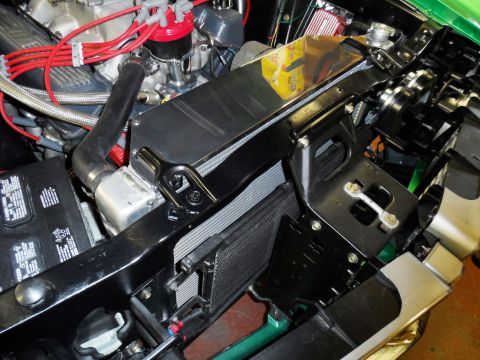 1971 Ford Ranchero - Close-up view of a vehicle's engine bay, highlighting the radiator, battery, and associated wiring.
