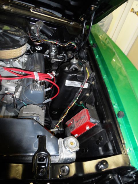 1971 Ford Ranchero - The engine bay of a 1971 Ford Ranchero shows a V8 engine, complete with red spark plug wires and a bright red ignition control module.