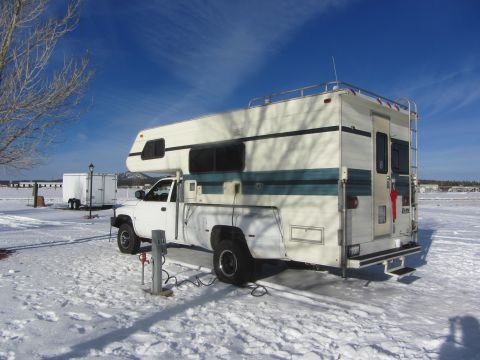 1997 Dodge 3500 - 1997 Dodge 3500 camper van parked in a snowy area with a clear blue sky.