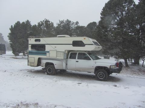 1997 Dodge 3500 - 1997 Dodge 3500 pickup truck equipped with a camper shell, seen during snowfall.