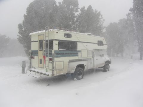 1997 Dodge 3500 - A camper truck is parked in a snowy landscape during a blizzard.