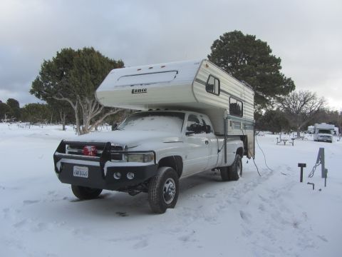1997 Dodge 3500 - Dodge 3500 pickup truck with camper shell in snowy conditions, with another RV in the background.