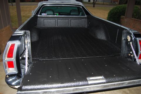 1975 Ford Ranchero - Rear view of a black Ford Ranchero pickup truck bed with a textured liner.