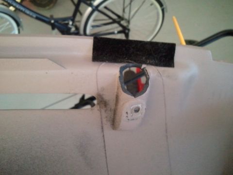 1994 Ford Bronco - Close-up of an interior dashboard panel showing a hole that has been cut out.