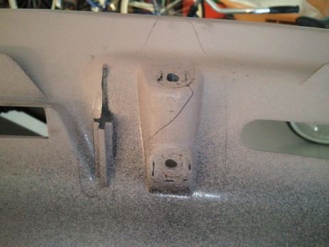 1994 Ford Bronco - Cracked plastic dashboard trim piece with visible mounting points and a cut.