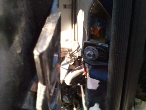 1994 Ford Bronco - A view of the complex wiring and mounting hardware within a vehicle's interior structure.