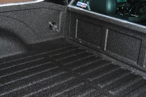 1975 Ford Ranchero - Black spray-in bed liner with ribbed texture and a tie-down loop.