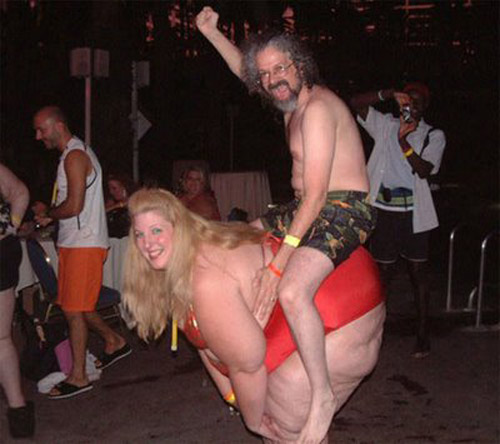 People at a party, one man riding on another person's back