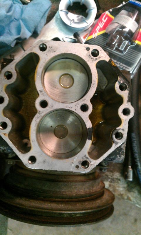 1995 Ford Bronco - Close-up view of an engine component, possibly a compressor or pump, showing two cylindrical chambers with oil.
