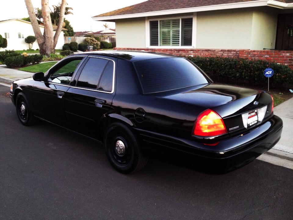 Black 2004 Ford Crown Victoria parked on a residential street, rear-right view