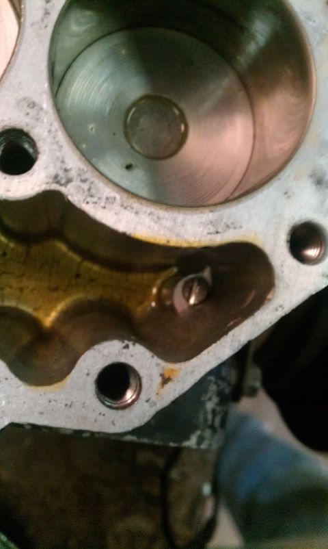 1995 Ford Bronco - Close-up of an engine cylinder head showing internal components and oil.