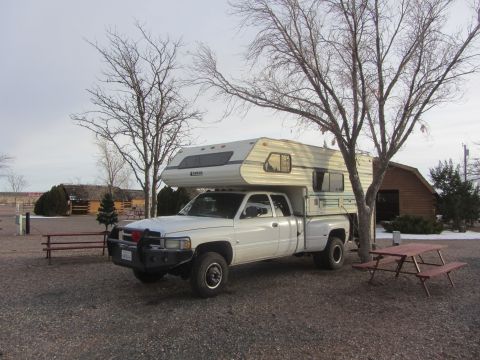 1997 Dodge 3500 - White 1997 Dodge 3500 pickup truck equipped with a camper shell is parked outdoors.