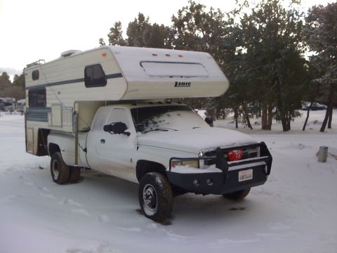 1997 Dodge 3500 - White 1997 Dodge 3500 pickup truck equipped with a camper shell, covered in snow.
