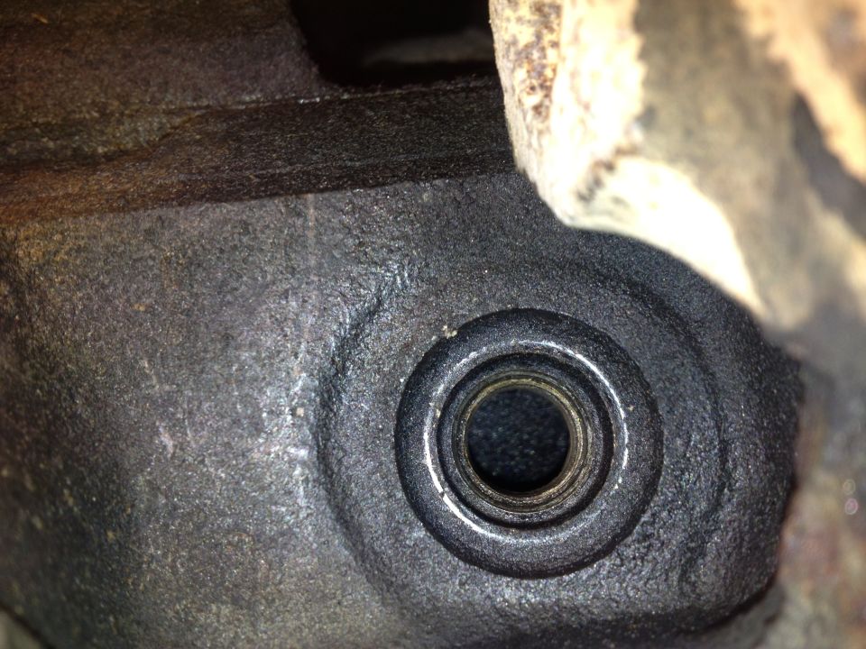 Close-up of a metal engine part with a circular opening