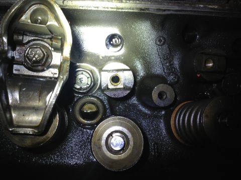 1989 Ford Bronco - Close-up view of engine valve train components, including rocker arms, valves, and springs.