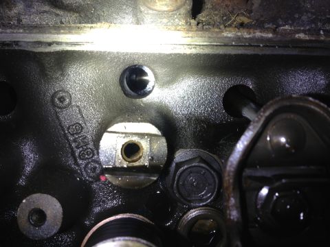 1989 Ford Bronco - Close-up view of an engine block casting, showing some stamped numbers and mechanical components.