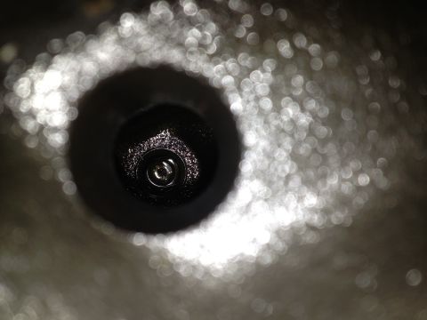 1989 Ford Bronco - A view into a spark plug hole, showing the threads and the central electrode.