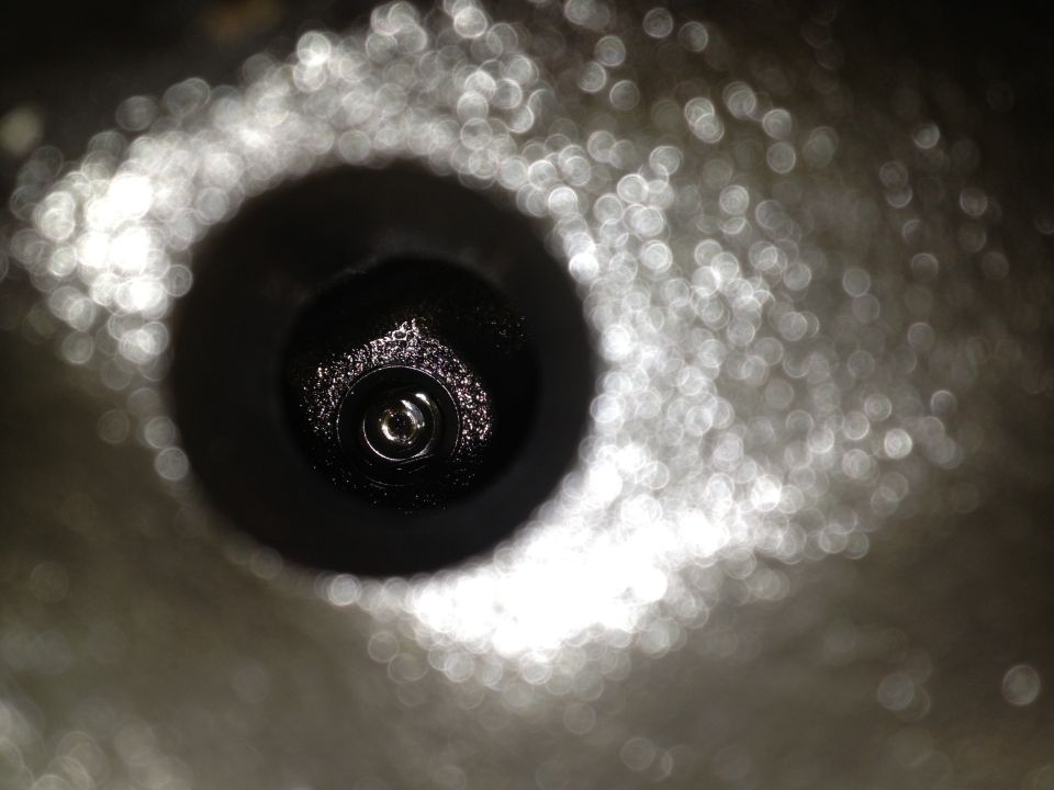 Close-up of a spark plug hole with some carbon buildup