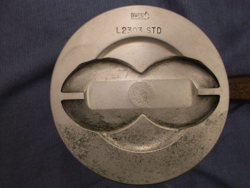 Piston marked L2303 STD with a front indicator