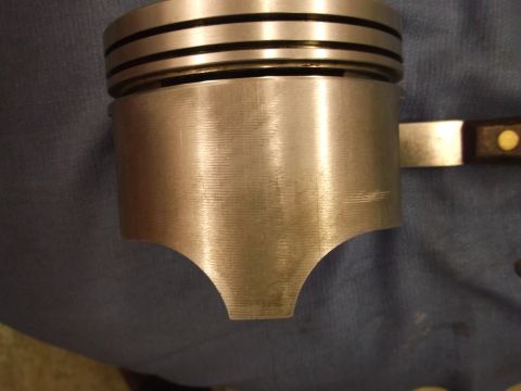 1971 Ford Ranchero - Close-up view of a metal piston, showing its three ring grooves and distinctive cutouts at the bottom.
