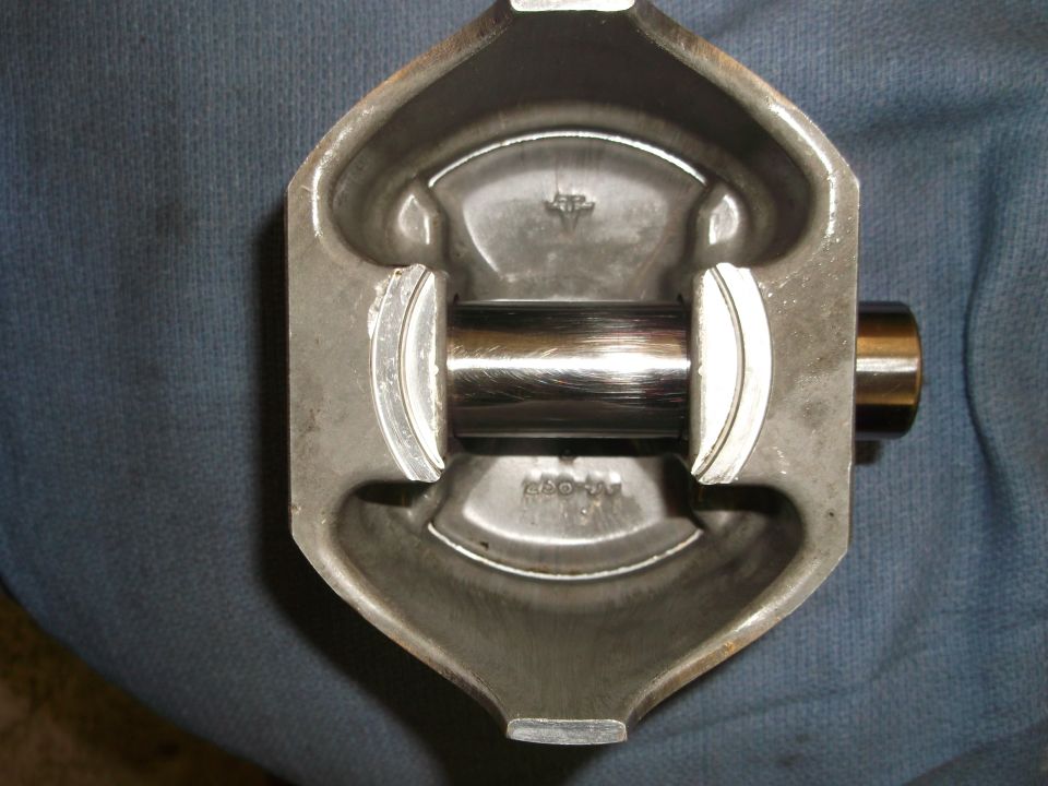 Close-up of a piston with a connecting rod pin visible