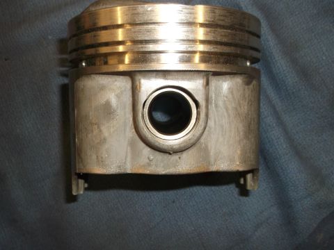 1971 Ford Ranchero - This is a close-up view of a single engine piston, showing its top rings and the bore for the wrist pin.
