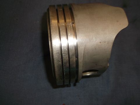 1971 Ford Ranchero - Close-up view of a single piston, showing its four distinct ring grooves.