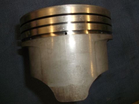 1971 Ford Ranchero - This is a close-up view of a single engine piston, showing its top section with distinct ring grooves.