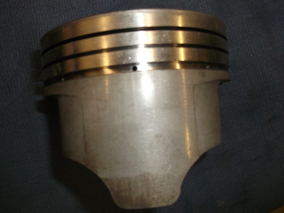 Close-up of an engine piston with three ring grooves at the top