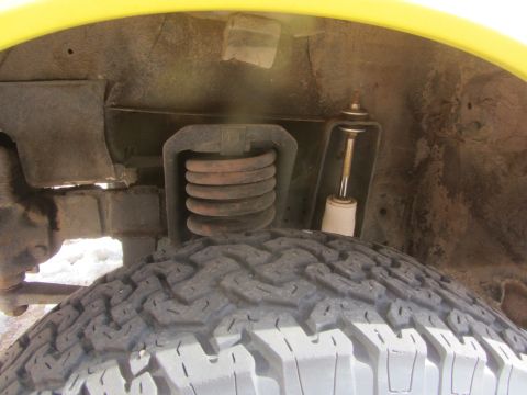 1964 Ford Ranchero - Front suspension components and tire tread detail of a vehicle.