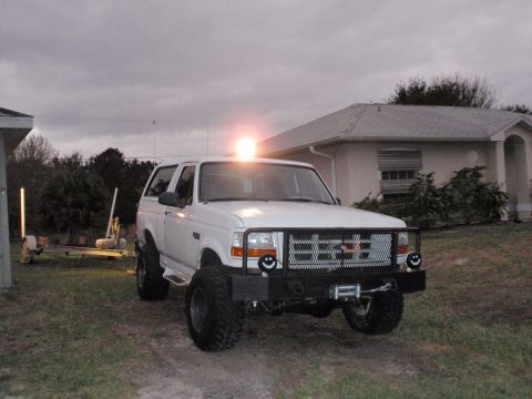 1995 Ford Bronco - This SUV features a custom grille with smiley face lights and a winch mounted on the front bumper.