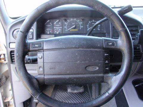1995 Ford Bronco - The interior of a 1992 Ford Bronco, with a worn steering wheel and a clear view of the dashboard gauges.