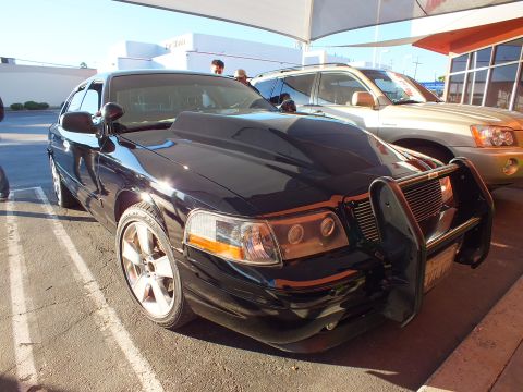 2003 Ford Crown Victoria - Front quarter of a customized black Crown Victoria parked at a detailing lot in sunlight.