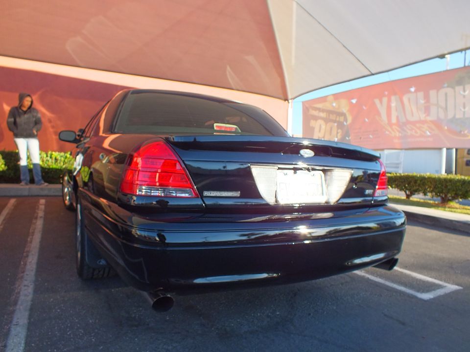 Black Ford Crown Victoria Police Interceptor rear view in parking lot under canopy