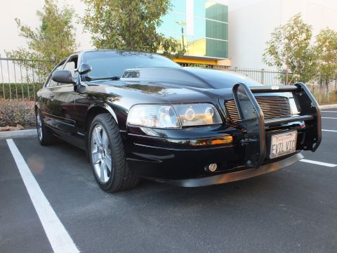 2003 Ford Crown Victoria - Front-right of a black Crown Victoria showing brush guard, billet grille and EVIL VIC plate.