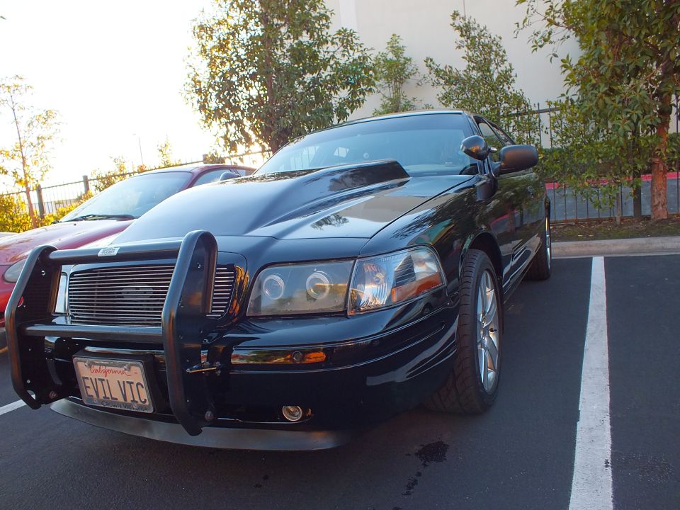 Black Crown Victoria front three-quarter with billet grille guard and alloy wheels
