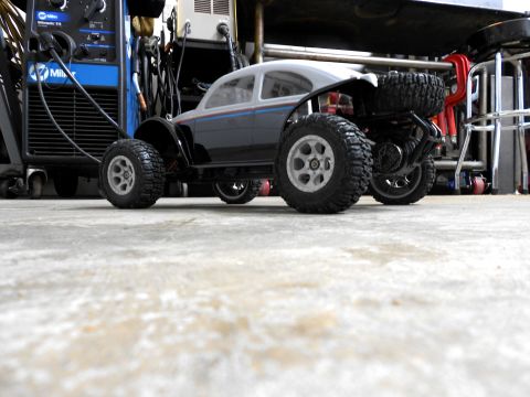 1996 Ford Bronco - RC car with off-road tires and a spare tire mounted on the back, parked near welding equipment.