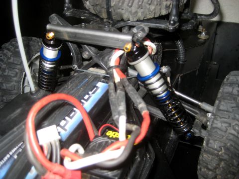 1996 Ford Bronco - Close-up view of the suspension system and battery of an RC car, showing intricate wiring and shock absorbers.