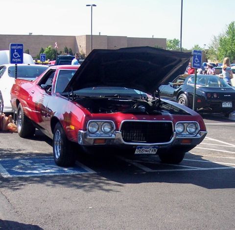 1972 Ford Ranchero - 1972 Ford Ranchero with hood open, parked in a handicapped spot. Another vehicle is visible behind it.
