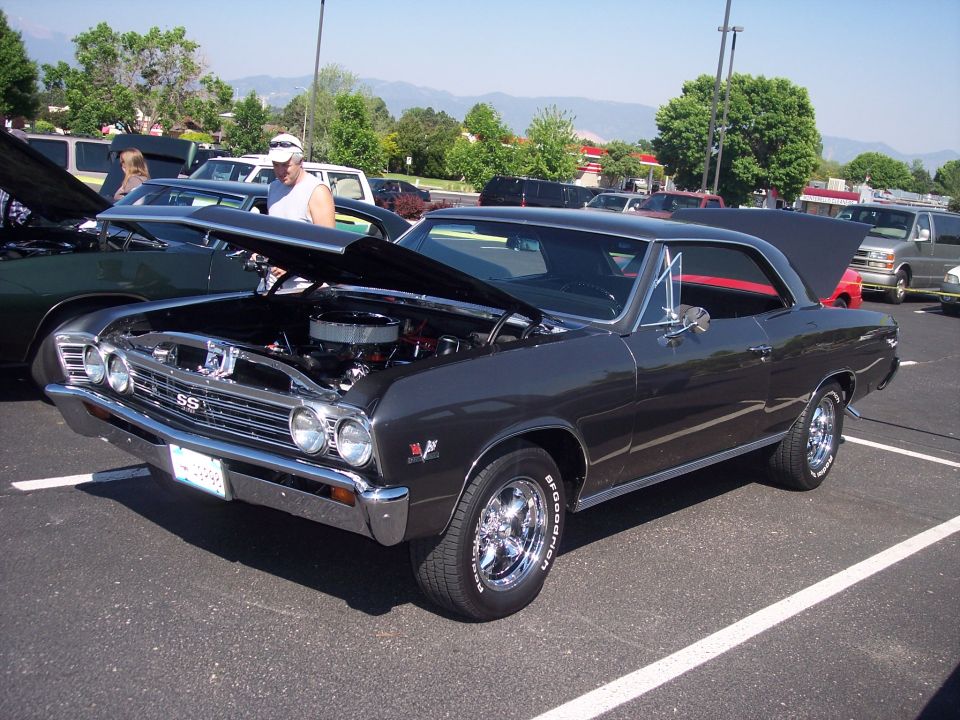 1967 Chevrolet Chevelle SS with hood open, parked next to another car