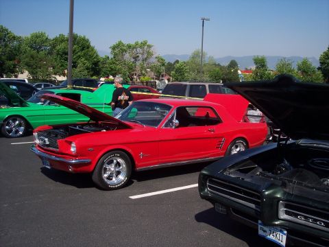 1972 Ford Ranchero - A red 1965 Ford Mustang coupe is displayed with its hood open at an outdoor car event.