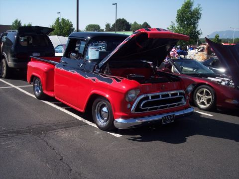 1972 Ford Ranchero - A classic pickup truck with a custom paint job is displayed at an outdoor event alongside other vehicles.