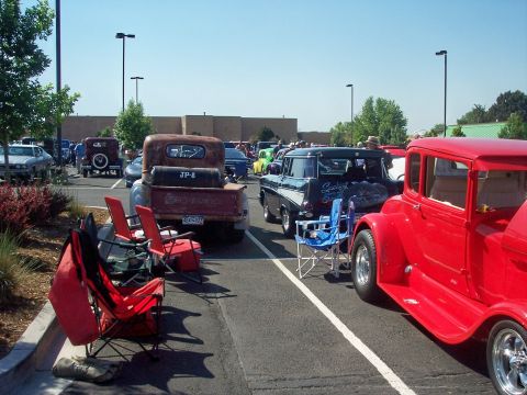 1972 Ford Ranchero - A gathering of vintage vehicles is displayed in a parking lot under a clear blue sky.