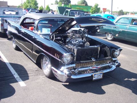 1972 Ford Ranchero - Modified 1957 Chevrolet Bel Air convertible at an outdoor car show.