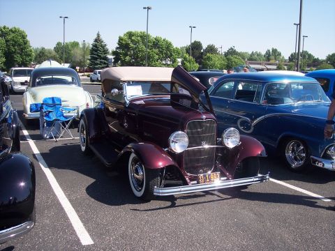 1972 Ford Ranchero - A maroon 1932 convertible hot rod is displayed with its hood open, alongside other classic vehicles.