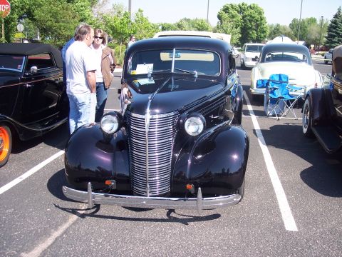 1972 Ford Ranchero - 1939 Chevrolet Master Deluxe sedan on display at a car show with other vehicles present.