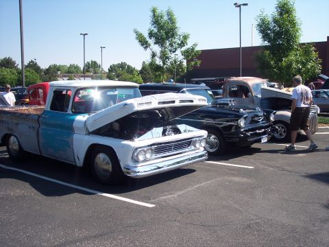 1972 Ford Ranchero - Multiple classic trucks and a car displayed at an outdoor event under a clear sky.