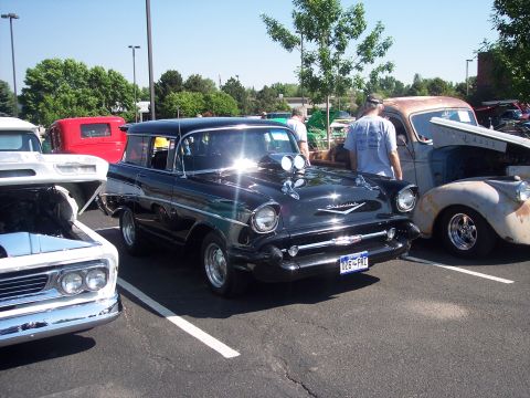 1972 Ford Ranchero - A black 1957 Chevrolet station wagon is parked next to other vehicles at an outdoor event.